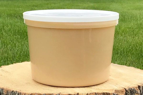 pail of light colored honey
