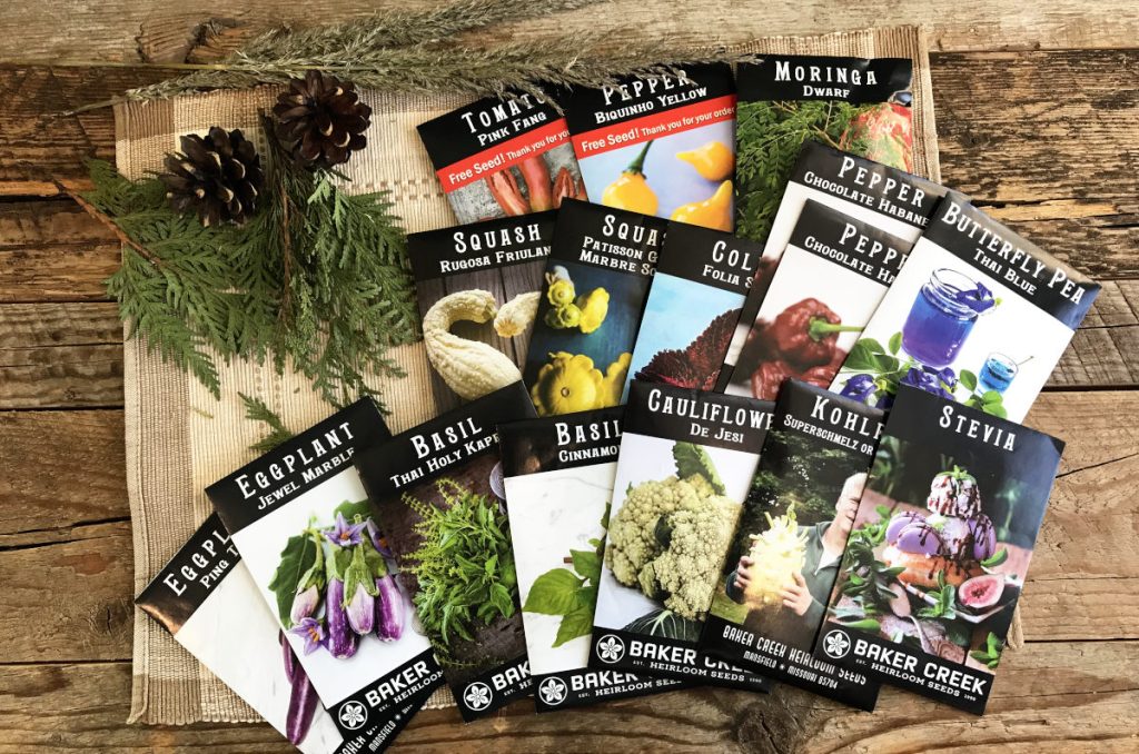 Baker Creek seed packets displayed on weathered wood planks