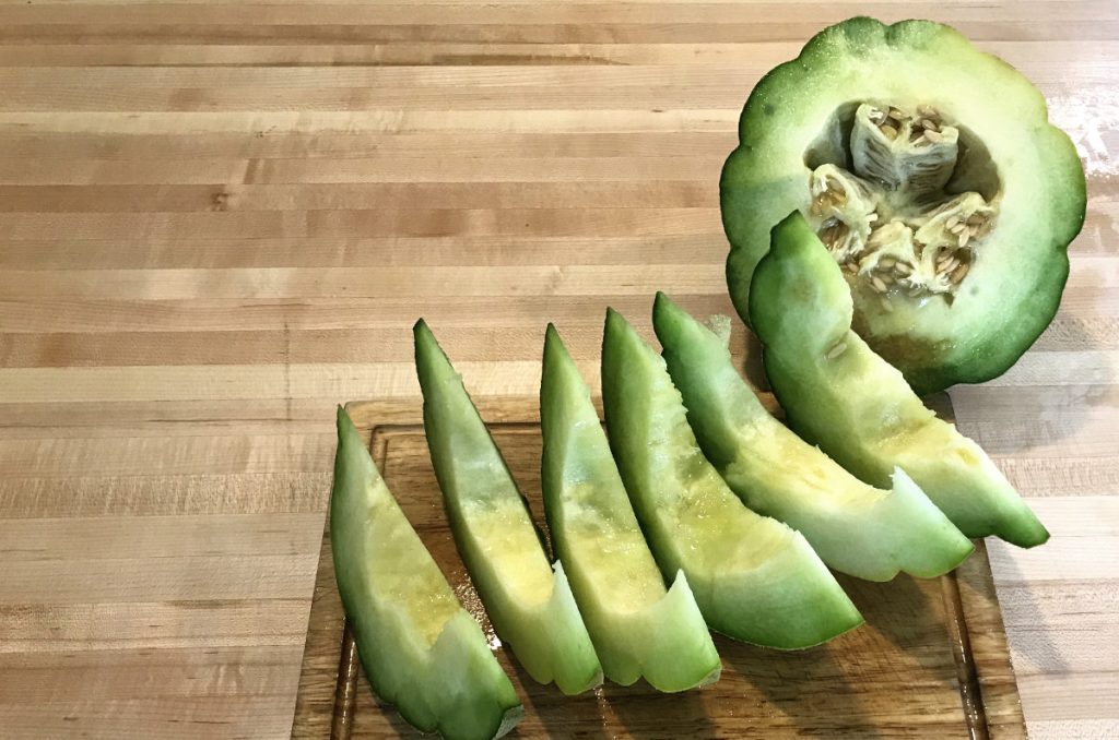 sliced montreal market melon on a wooden cutting board