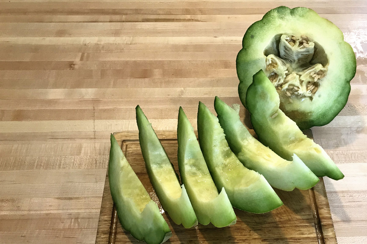 sliced montreal market melon on a wooden cutting board