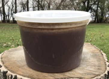 pail of dark wildflower honey