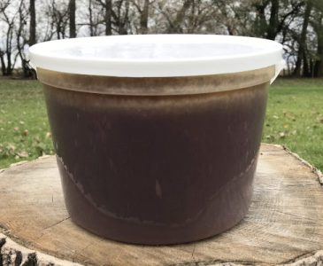 pail of dark wildflower honey
