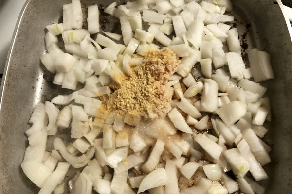 onions frying in a pan with spices