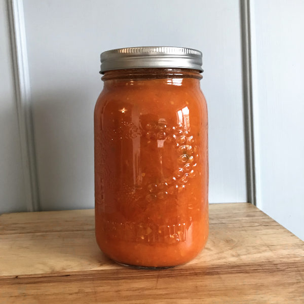Glass jar of blended canned tomatoes