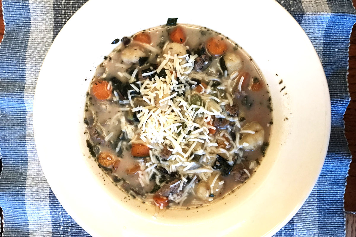 gnocchi soup in bowl and garnished with Parmesan cheese