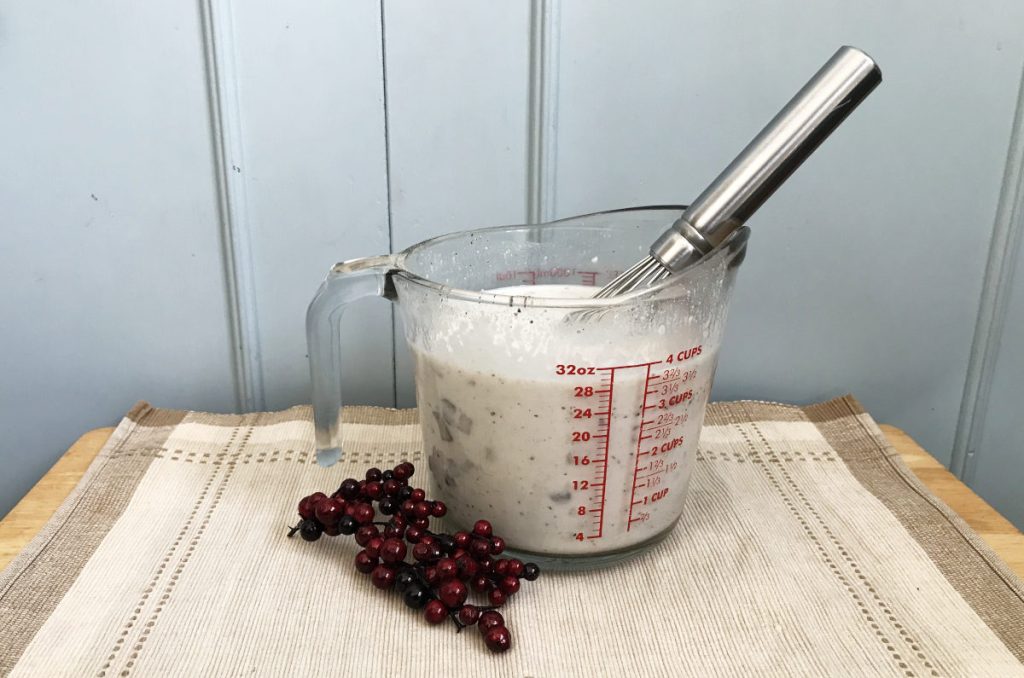 mushroom soup sauce in a measuring cup with whisk