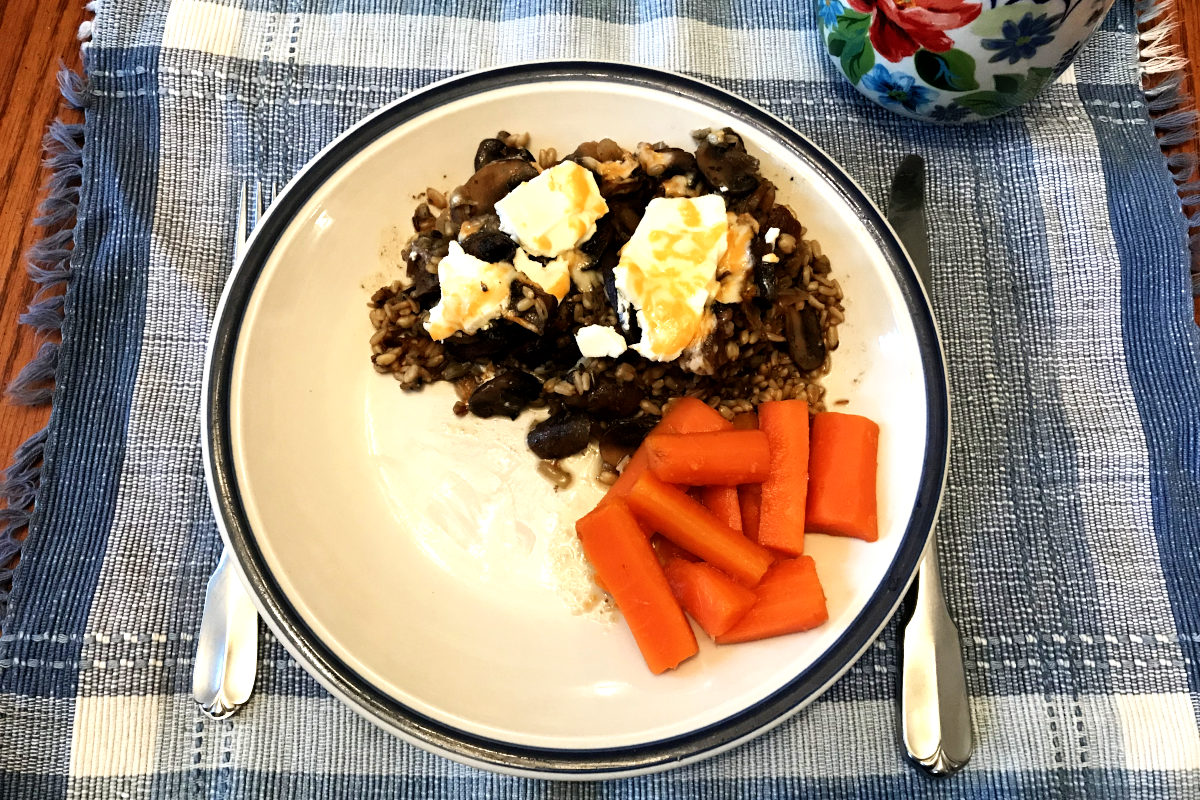 Ultimate Wild Rice Bake on plate on placemat with a side of carrots