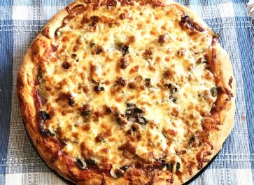 homemade pizza with golden crust and golden cheese