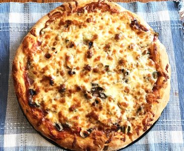 homemade pizza with golden crust and golden cheese