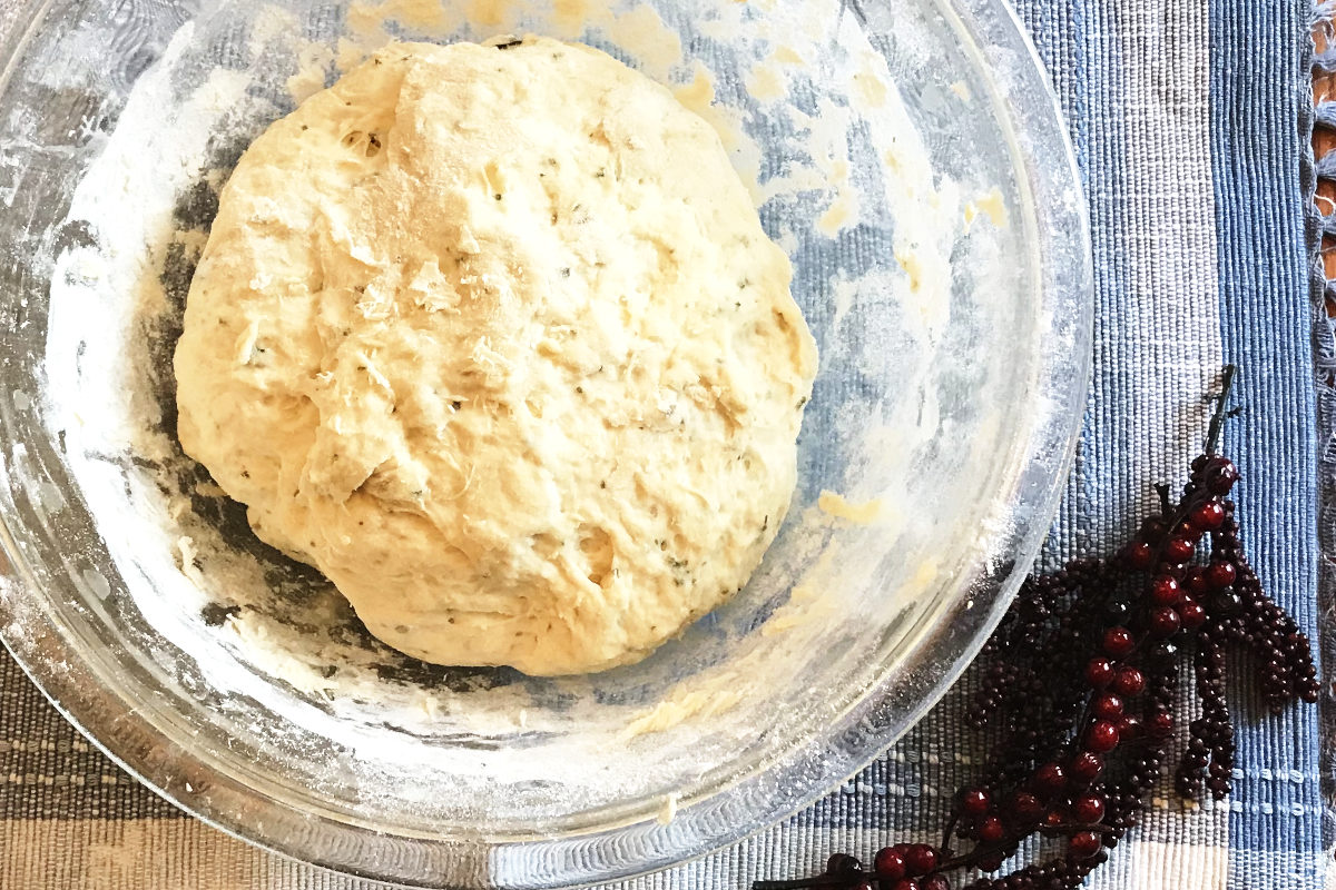 ball of dough in mixing blowl on placemat