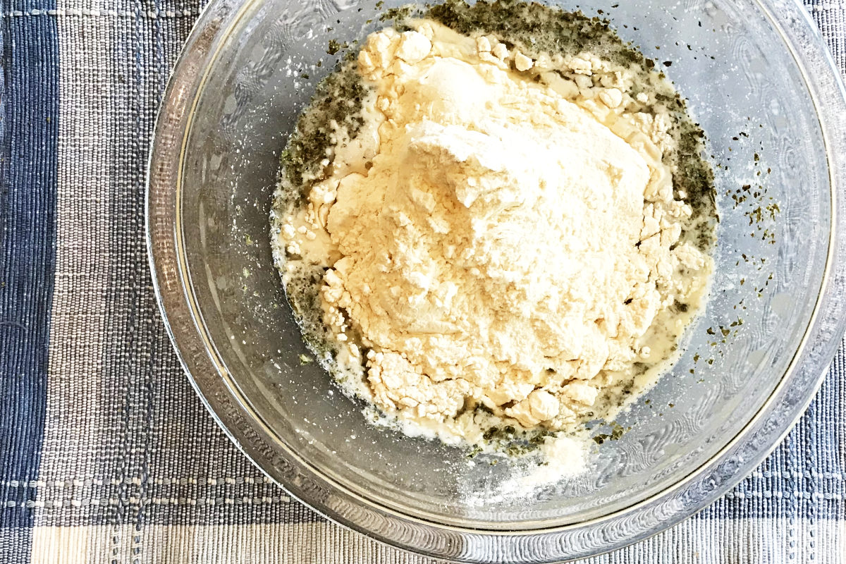 Yeast mixture in bowl with flour added
