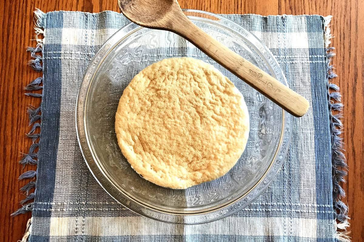 grown yeast in mixing bowl on placemat