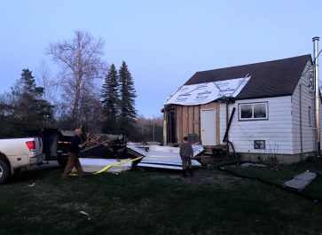 Entryway ripped off by truck and lying on the ground of old house remodel