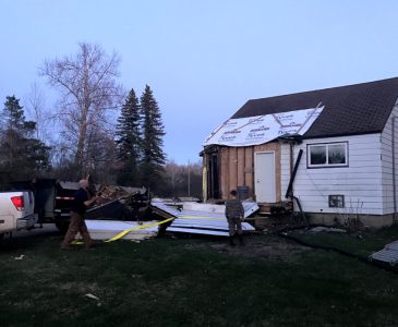 Entryway ripped off by truck and lying on the ground of old house remodel