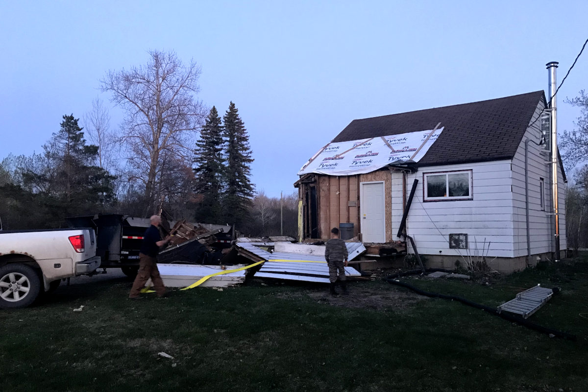 Entryway ripped off by truck and lying on the ground of old house remodel