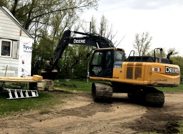 excavator begins digging the basement for our old house remodel