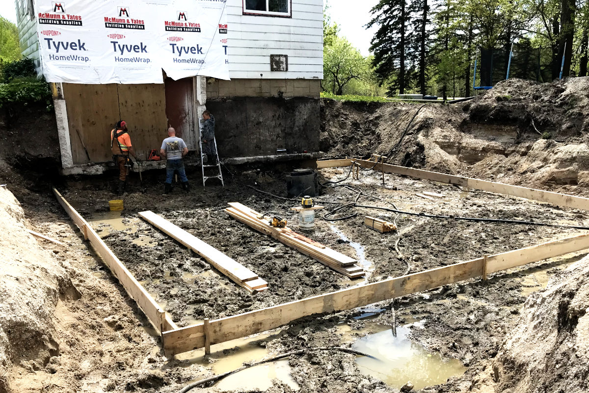 Forms for foundation footings being built for the addition on the old house remodel