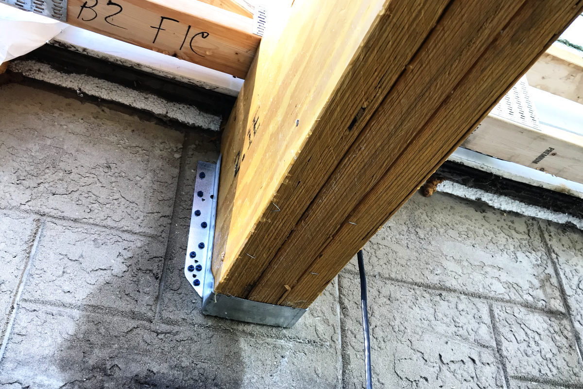 Wood beam with hanger attached to basement of the old house in the old house remodel