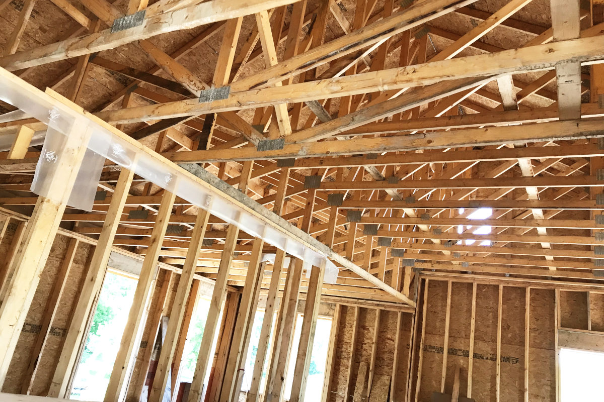 looking up at an angle into the trusses of the addition for our old house remodel