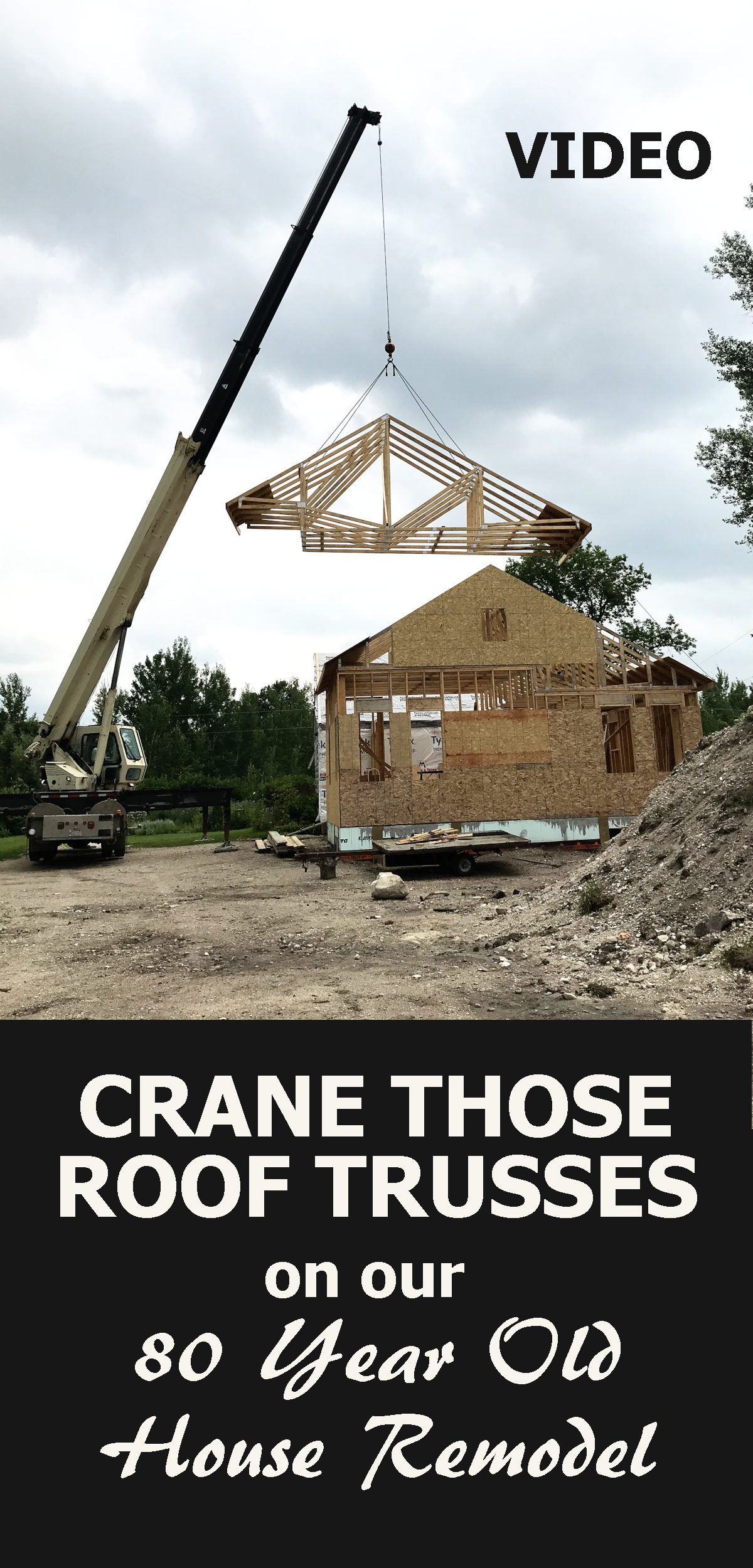 picture of crane raising the roof trusses above the house, with text reading crane those roof trusses on our old house remodel