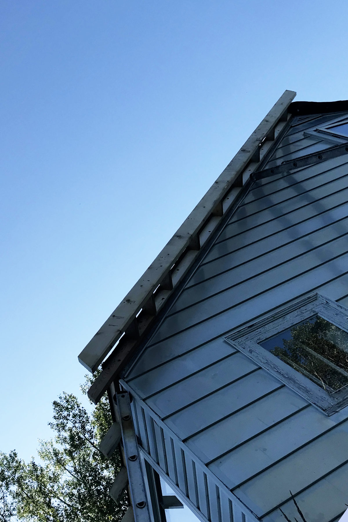 Close-up of one ladder of eaves attached to the old roof in our old house remodel