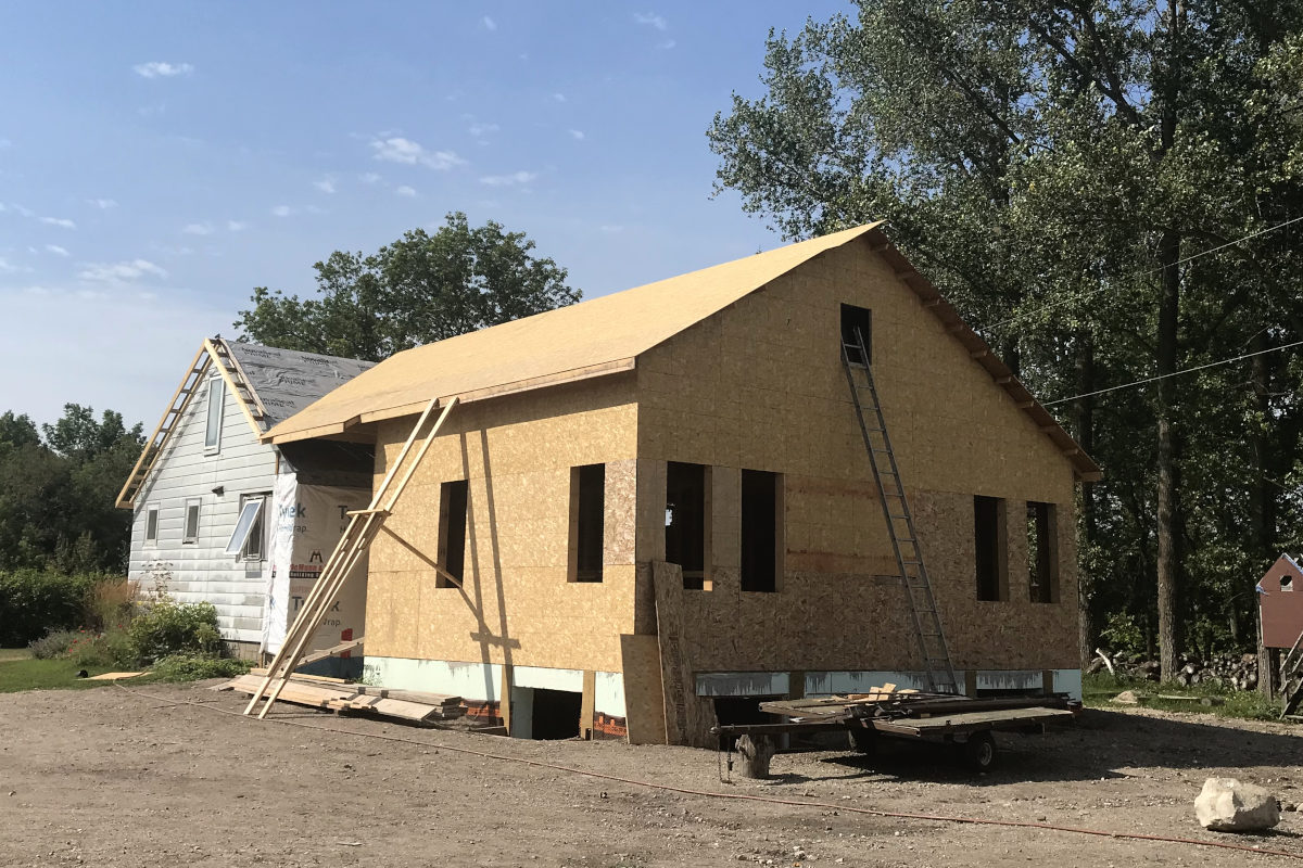 Addition of our old house remodel with sheeting on the roof and eaves attached to the old house.