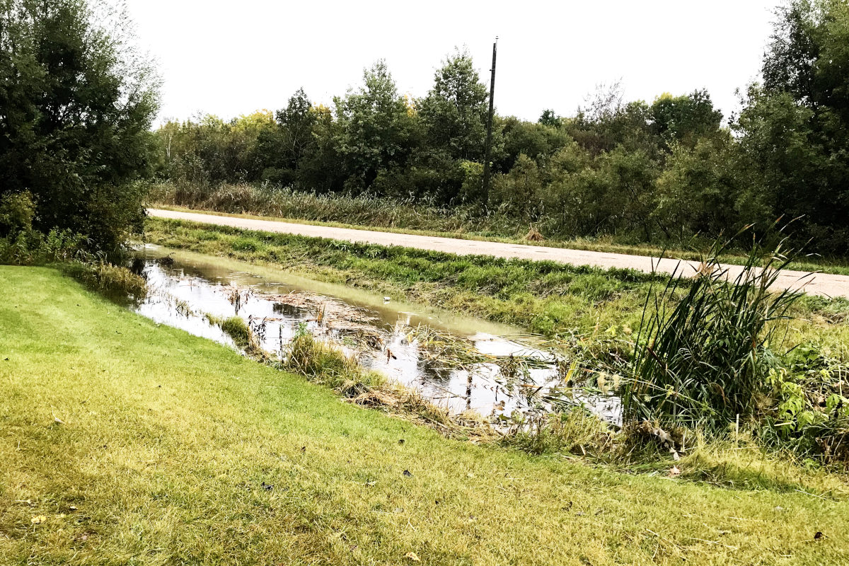 flooded ditch near old house remodel