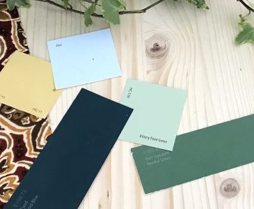 paint swatches for old house remodel on pine with deep red and gold fabric