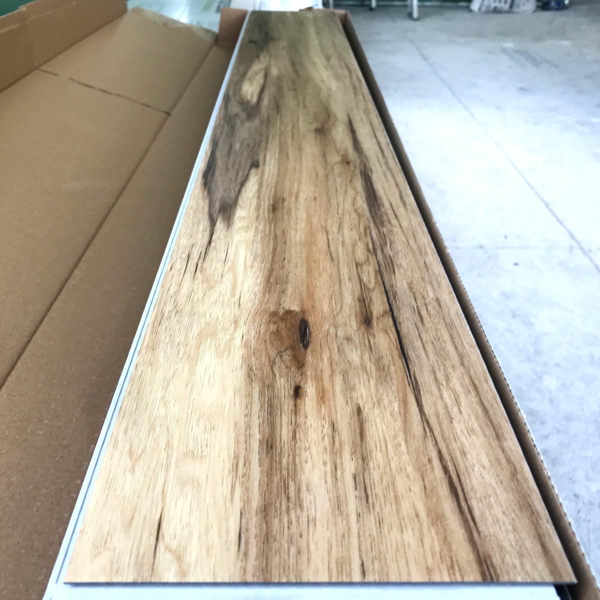 a plank floor board, medium brown with lots of grain.