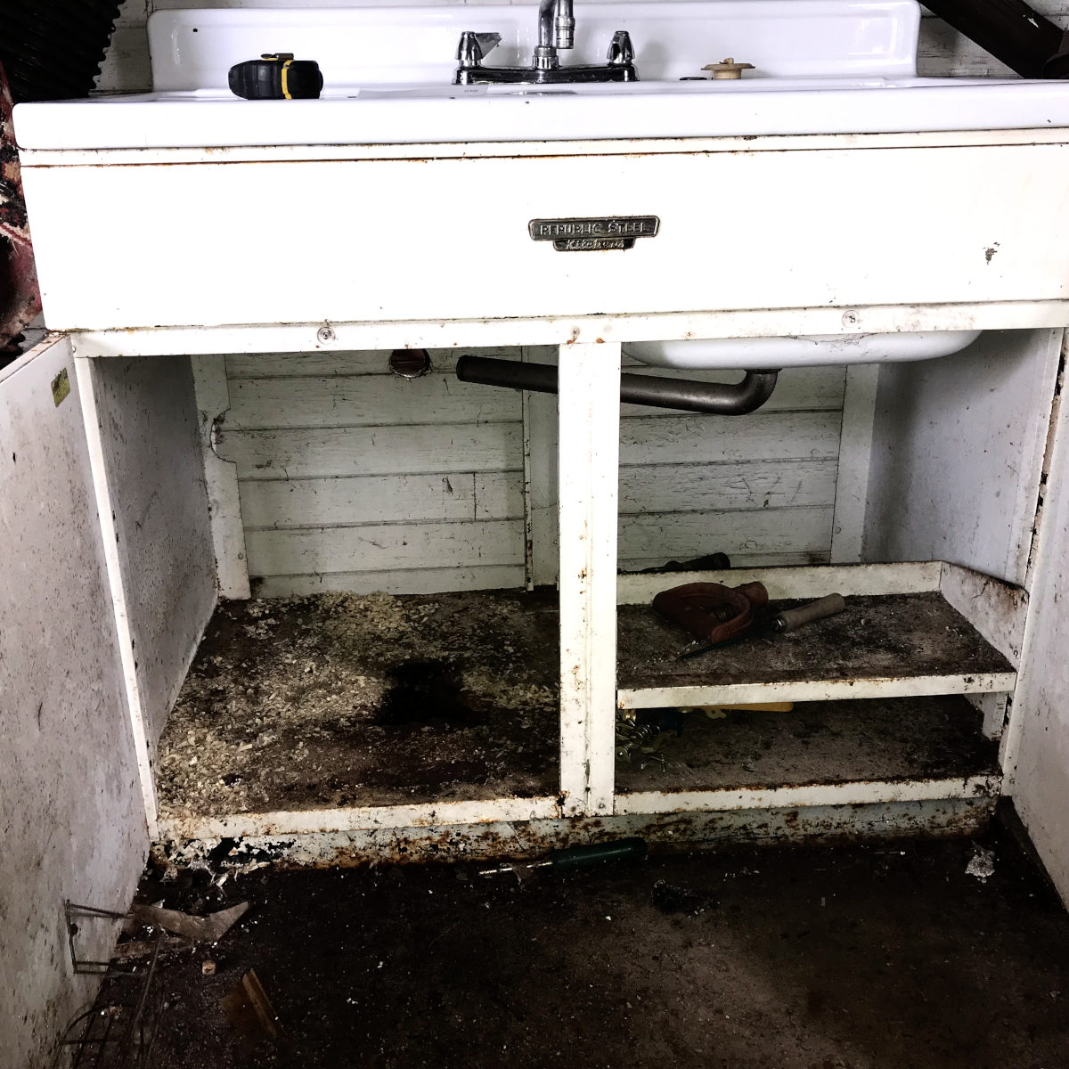 dirty, rusty original metal cabinet for enamel sink