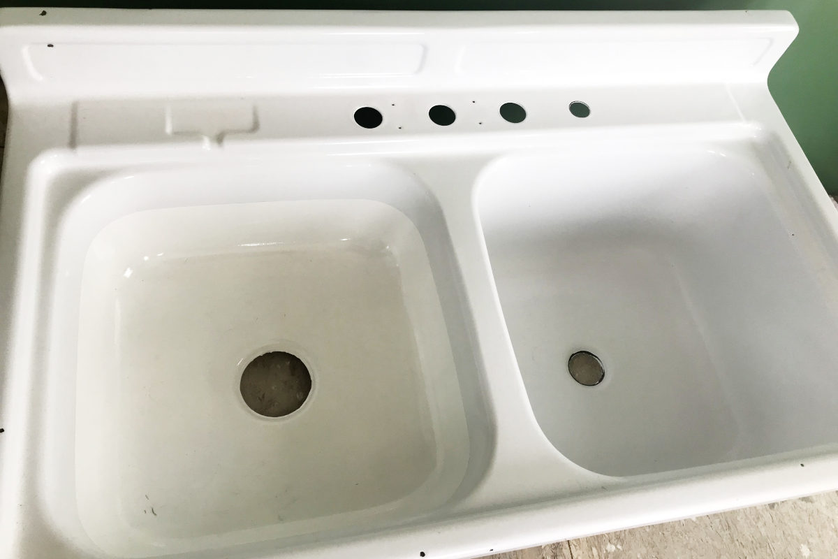 Old enamel sink with basin refinished with epoxy.