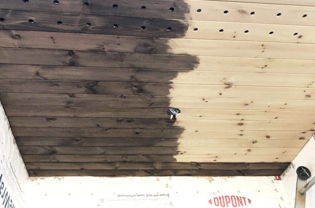 half stained tongue and groove porch ceiling in old house remodel