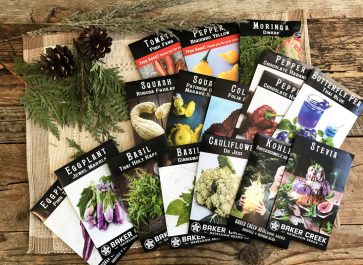 Baker Creek seed packets displayed on weathered wood planks