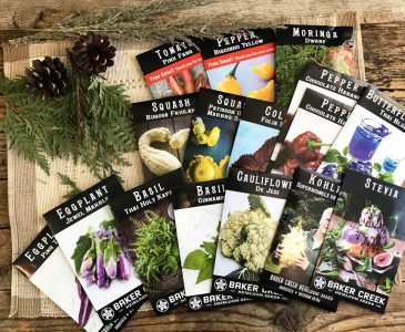 Baker Creek seed packets displayed on weathered wood planks