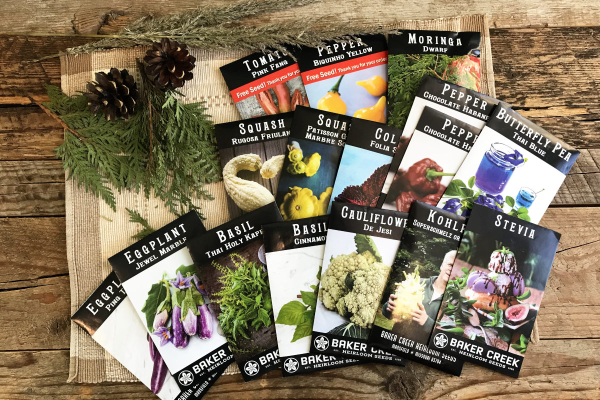 Baker Creek seed packets displayed on weathered wood planks