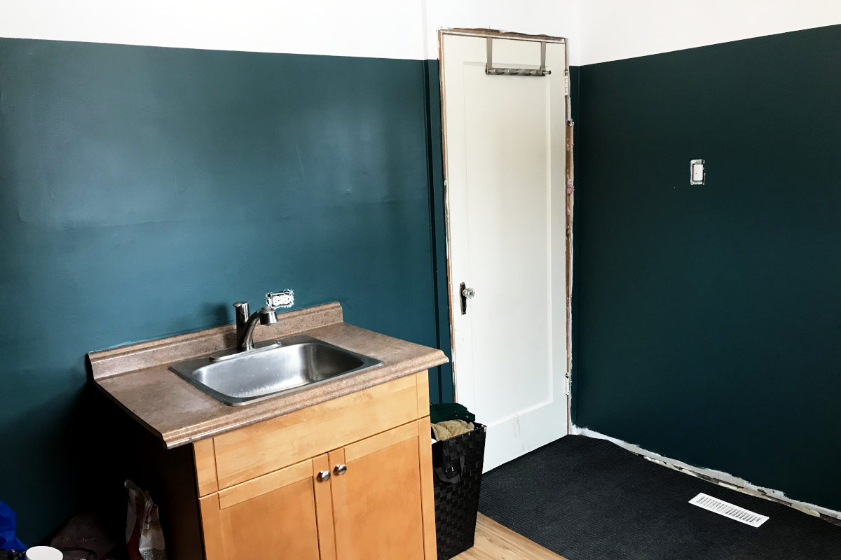 View of sink and interior door of painted mudroom