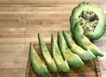 sliced montreal market melon on a wooden cutting board