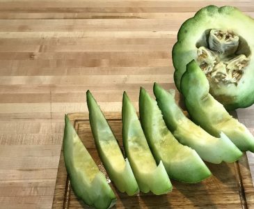 sliced montreal market melon on a wooden cutting board