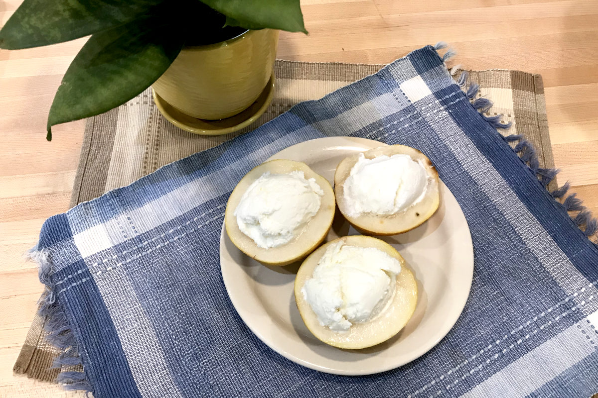 halved small melons with ice cream in the hollowed out centre.