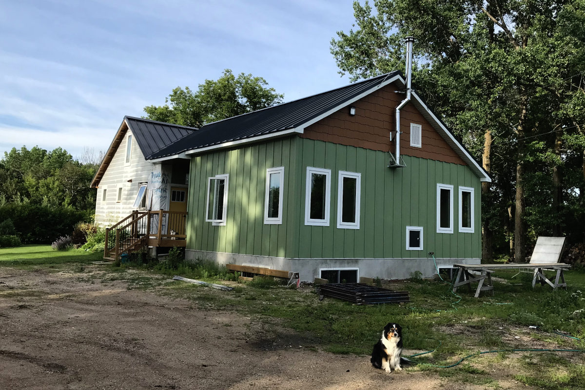 entire house with new siding completed on the addition, and old part of the house not completed.