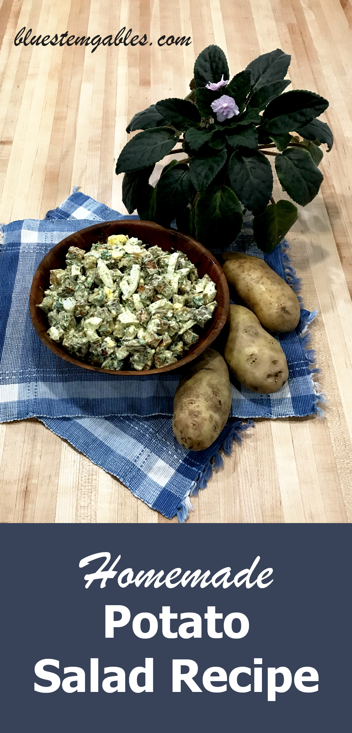 potato salad in wooden bowl on place mats with whole potatoes and a potted plant on butcher block with text reading homemade potato salad recipe